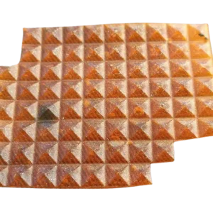 An amber solid-state hydrogel matrix sheet of premium LSD Gel Tabs shaped in a precise pyramidal grid.